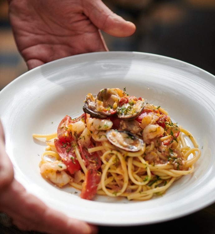 0019 - 2021 - Gees Restaurant & Bar - Oxford - High res - Food Hands Pasta Seafood - Web Feature