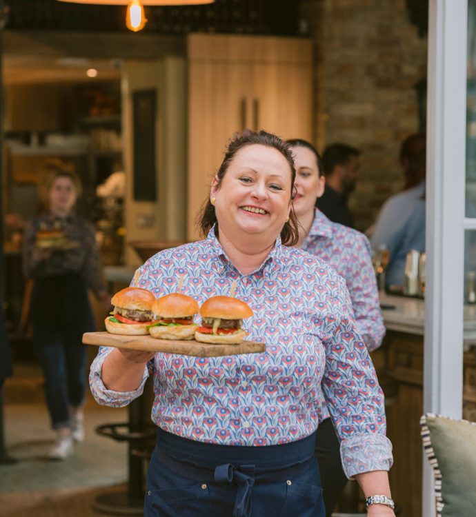 0067 - 2022 - Gees Restaurant & Bar - Oxford - High Res - Andrea Waitressing Burgers - Web Feature